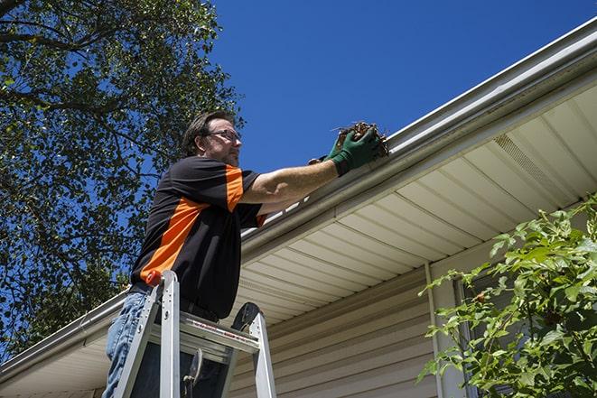 a construction worker repairing a damaged gutter in Alviso, CA